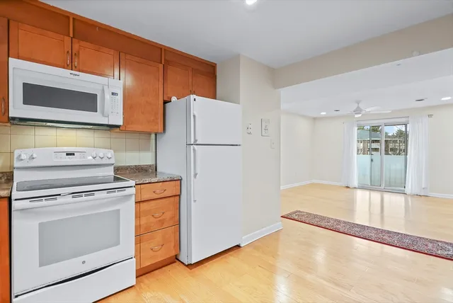 a kitchen with a stove a refrigerator and a microwave