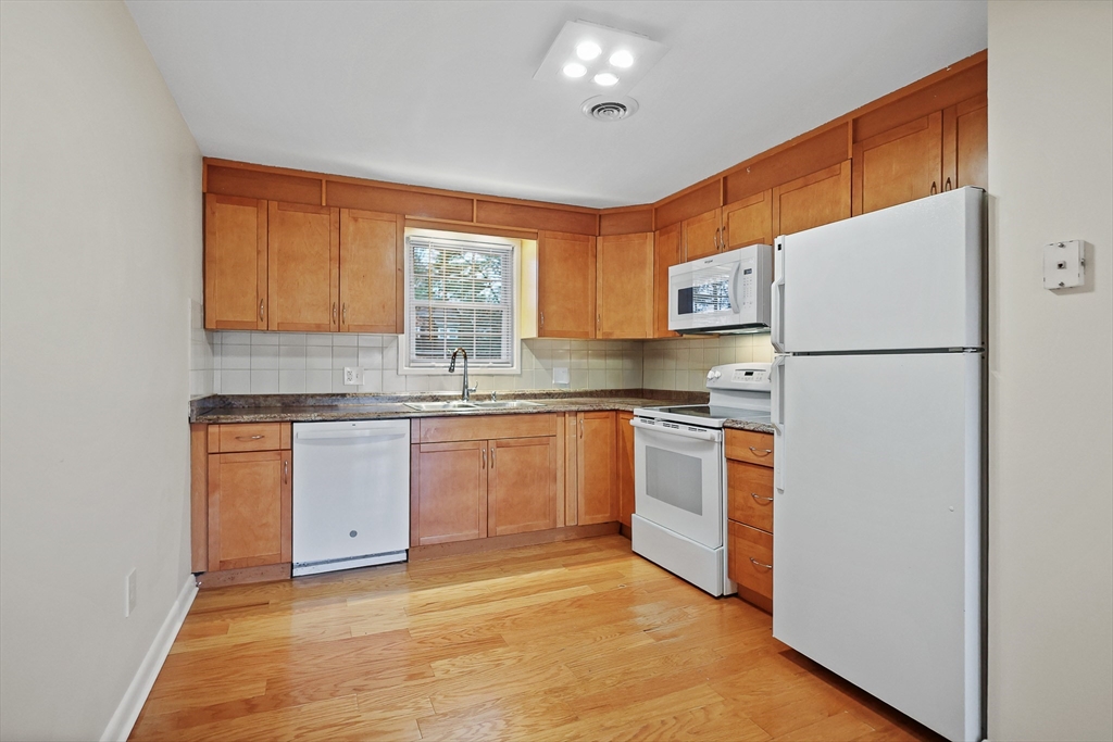 2 Constitution Way, Unit C Methuen, MA 01844 - Photo 6 of 14 a kitchen with a white cabinets and white appliances