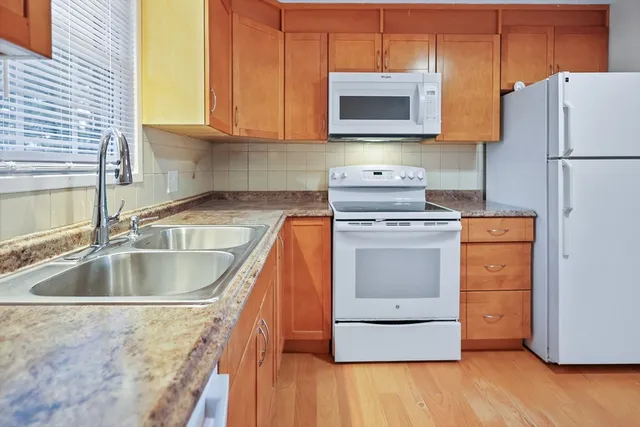 a kitchen with a sink stove and microwave