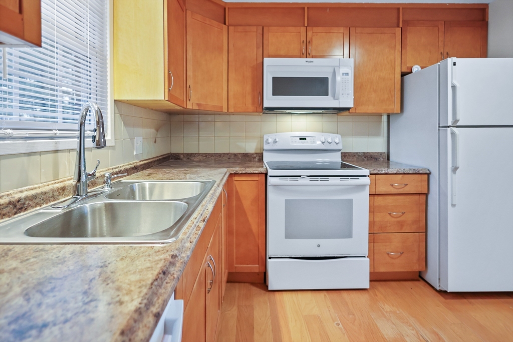 2 Constitution Way, Unit C Methuen, MA 01844 - Photo 7 of 14 a kitchen with a sink stove and microwave