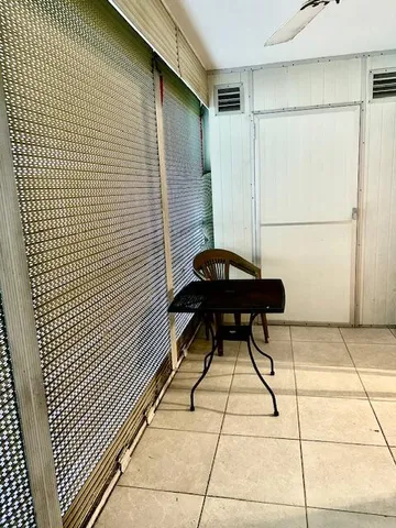 a view of a room with table and chairs