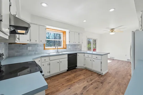 a kitchen with sink cabinets and window