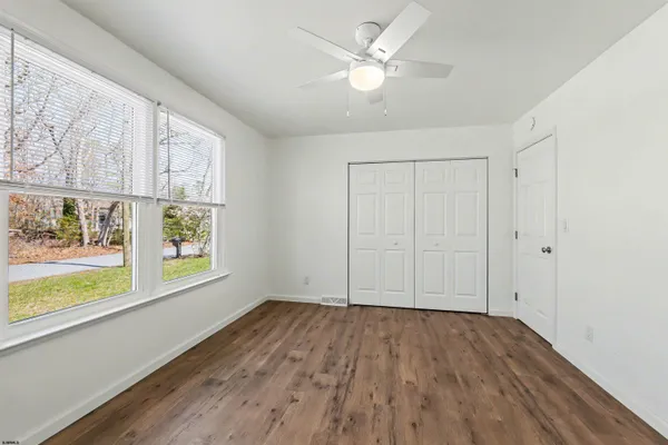 wooden floor in an empty room with a window