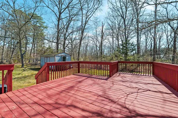 a balcony with wooden floor and trees