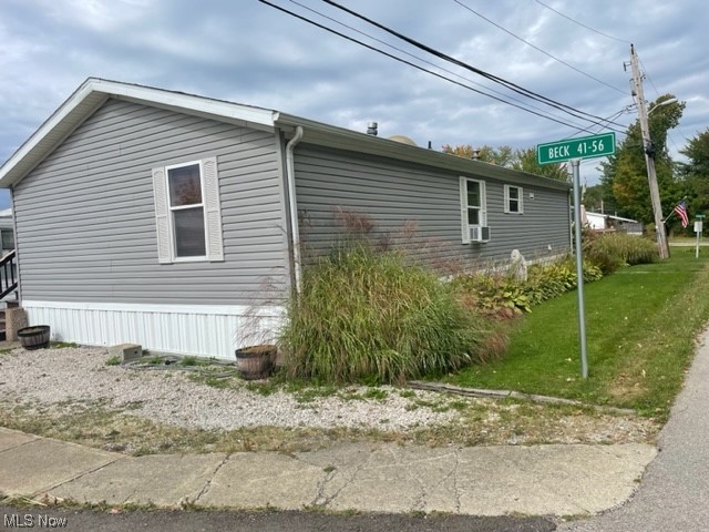 4534 Lake Road East, Unit 41 Geneva, OH 44041 - Photo 15 of 16 View of side of home with a lawn
