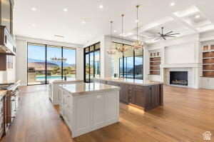 1141 East Lost Ridge Drive Washington, UT 84780 - Photo 39 of 108 Open-concept living area with wood-finish flooring, a coffered ceiling, and a prominent fireplace with built-in shelving