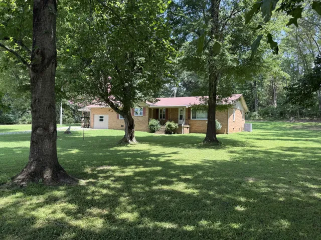a view of a house with a yard porch and sitting area