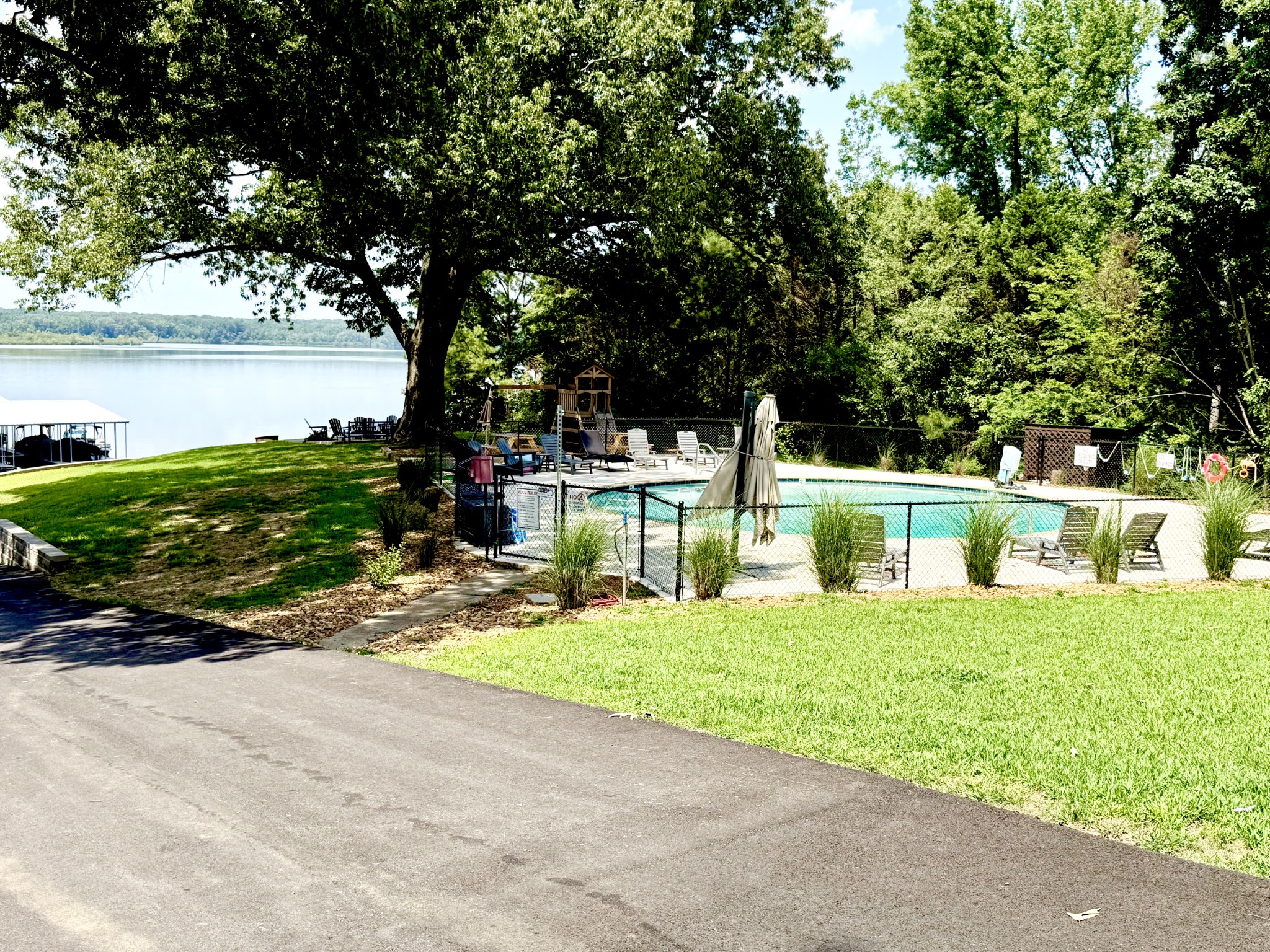 1520 Old Springville Road Springville, TN 38256 - Photo 13 of 16 a white house that has a tree in front of it