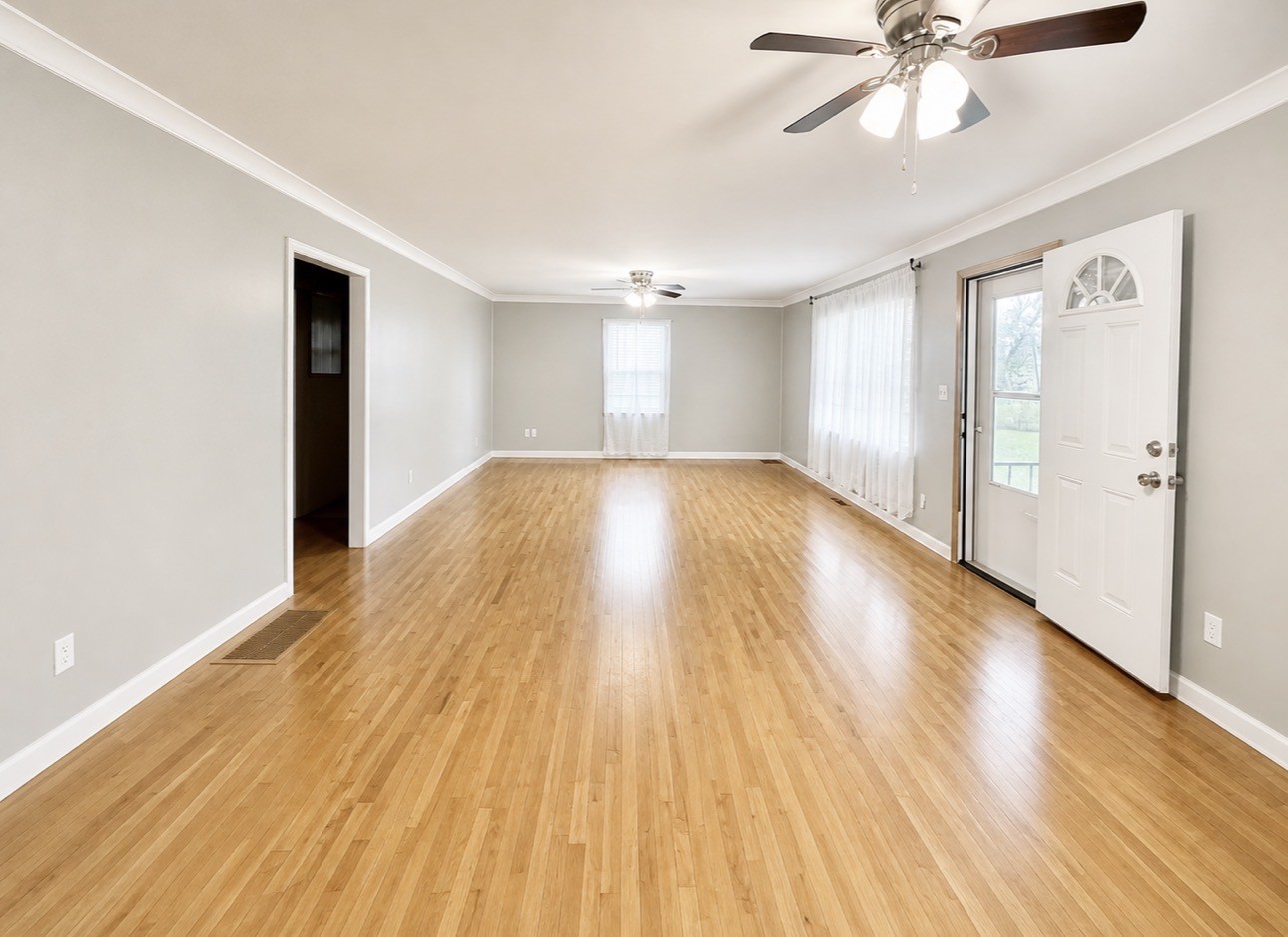 1520 Old Springville Road Springville, TN 38256 - Photo 2 of 22 an empty room with wooden floor and windows