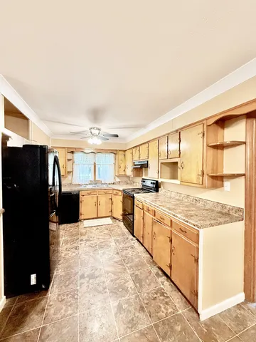 a kitchen with stainless steel appliances granite countertop a refrigerator and a stove top oven