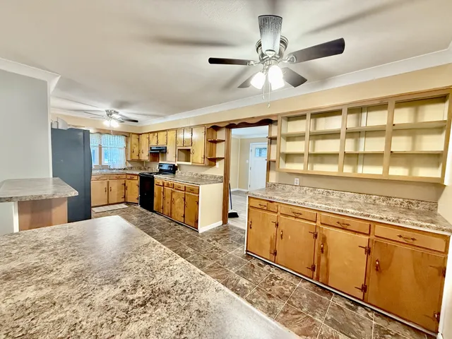 a kitchen with stainless steel appliances granite countertop a stove and cabinets