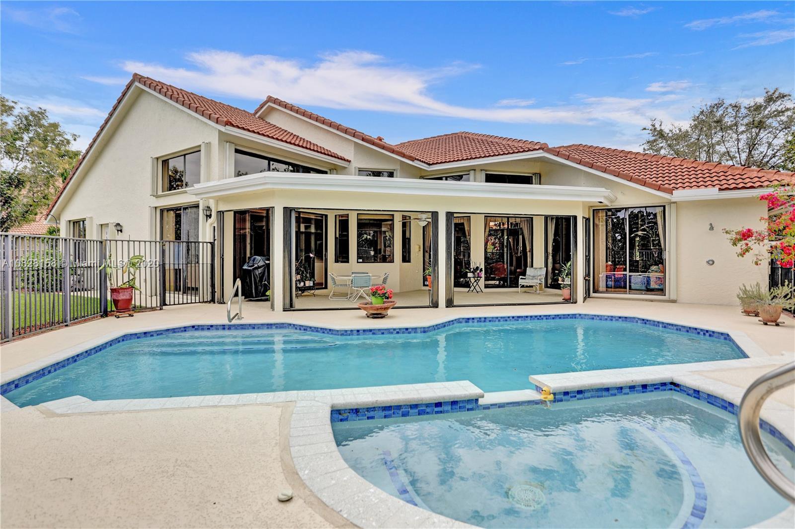 390 Alexandra Circle Weston, FL 33326 - Photo 1 of 71 front view of a house with swimming pool and porch