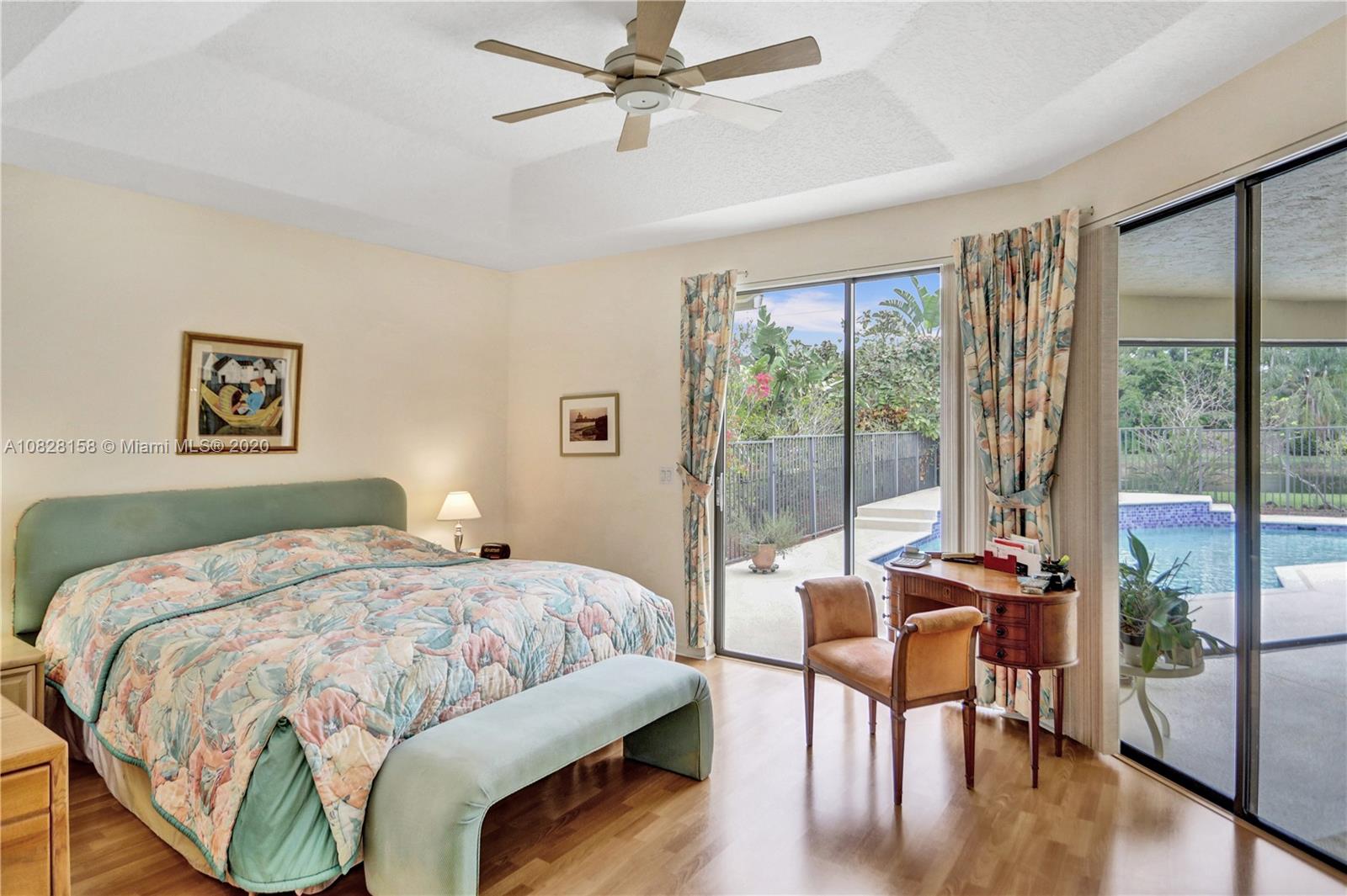 390 Alexandra Circle Weston, FL 33326 - Photo 12 of 71 a bedroom with a bed and a table