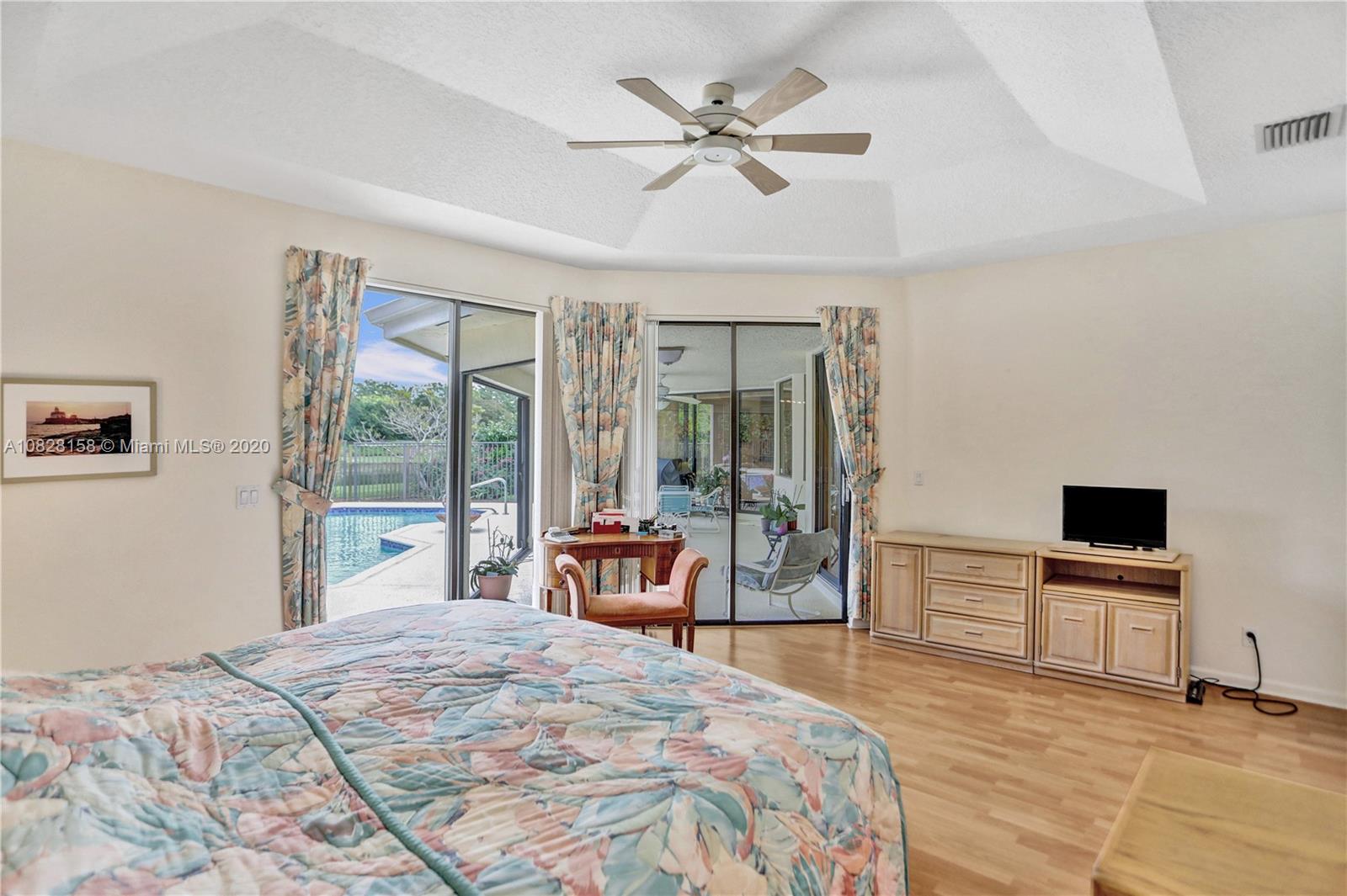 390 Alexandra Circle Weston, FL 33326 - Photo 13 of 71 a bedroom with a large bed and a tv