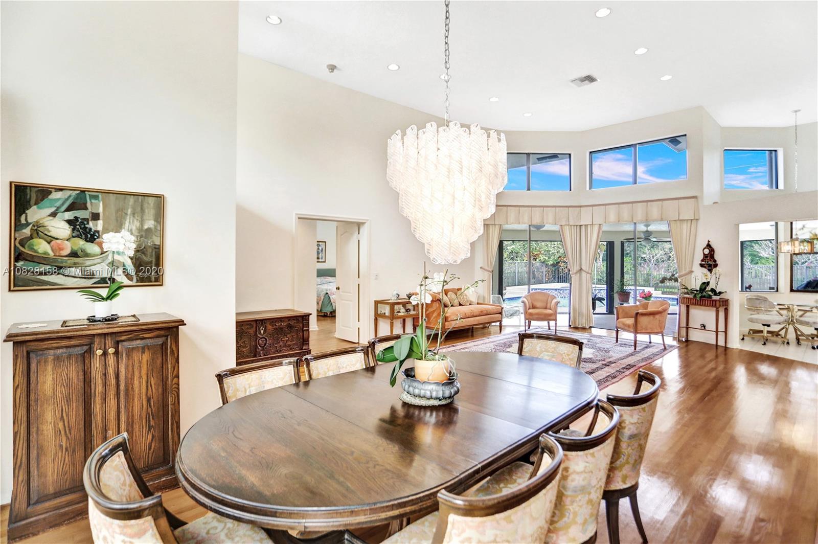 390 Alexandra Circle Weston, FL 33326 - Photo 20 of 71 a dining room with furniture a rug and wooden floor