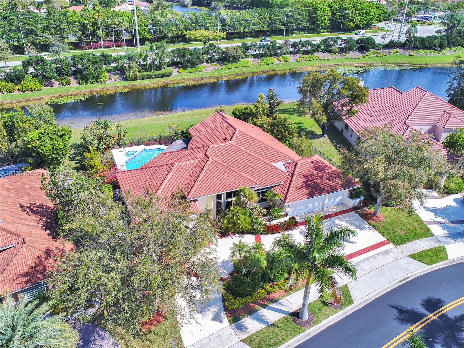 390 Alexandra Circle Weston, FL 33326 - Photo 2 of 71 an aerial view of lake residential house with outdoor space and swimming pool