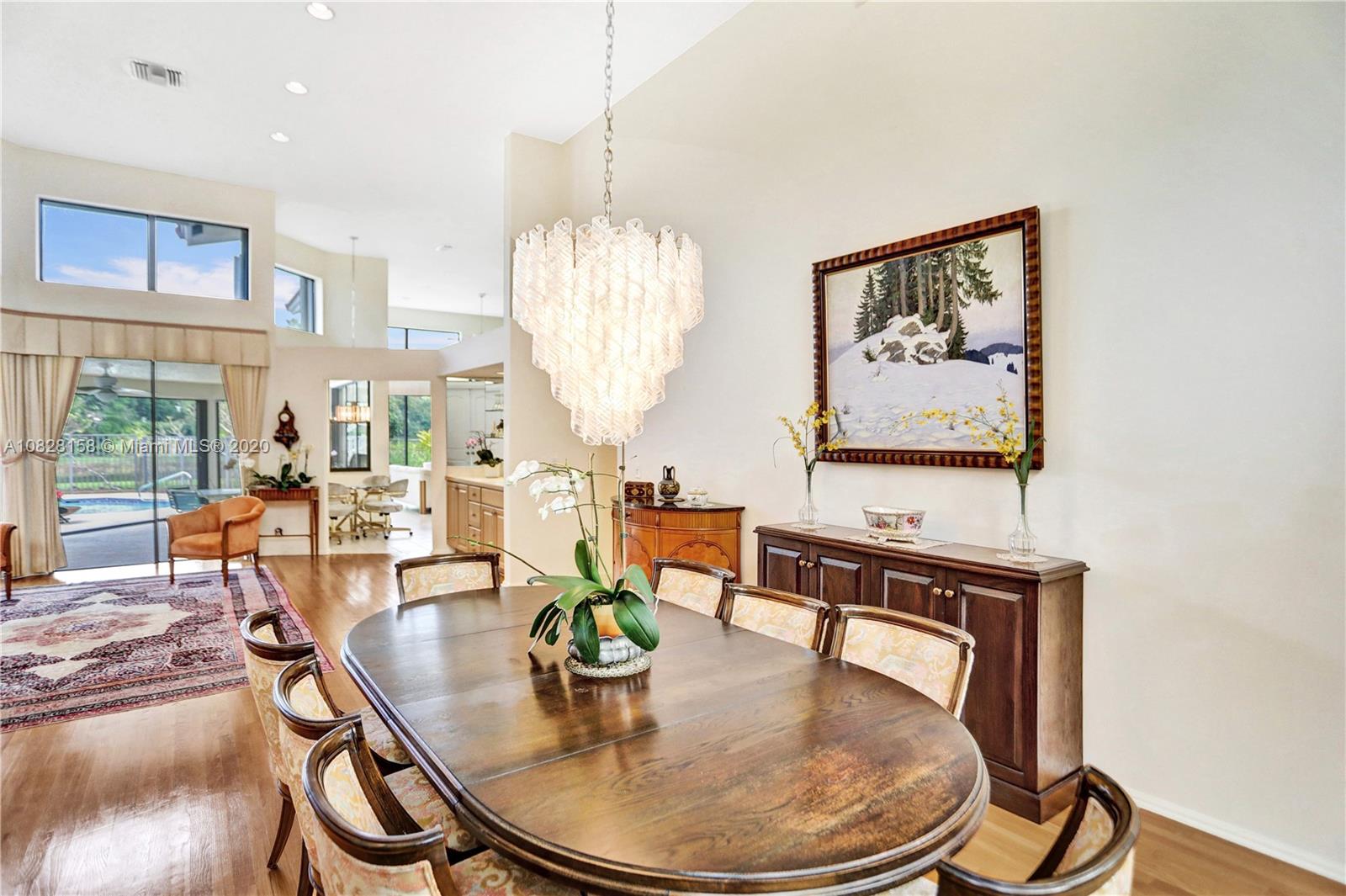 390 Alexandra Circle Weston, FL 33326 - Photo 21 of 71 a dining room with furniture a chandelier and wooden floor