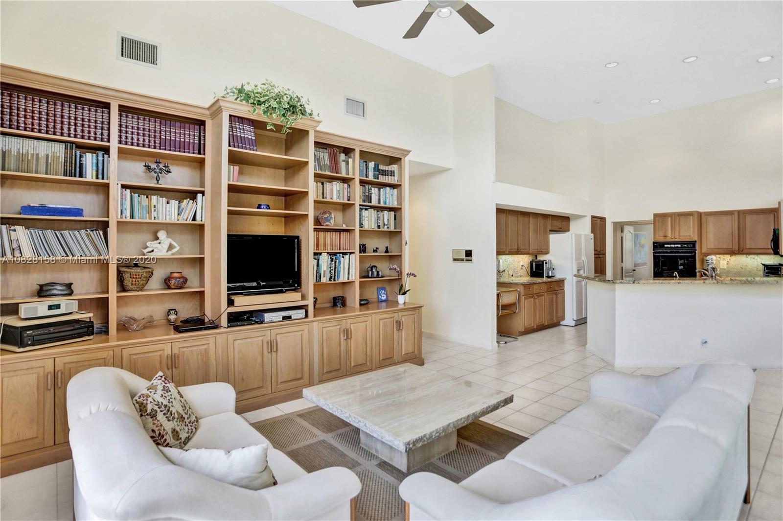 390 Alexandra Circle Weston, FL 33326 - Photo 25 of 71 a living room with furniture kitchen view and a flat screen tv