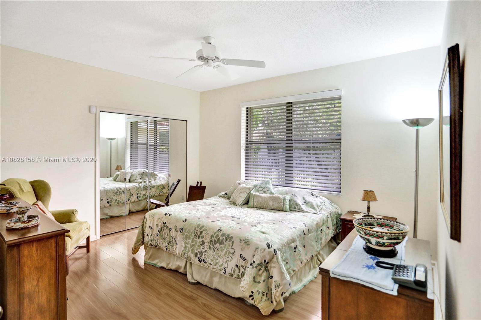 390 Alexandra Circle Weston, FL 33326 - Photo 39 of 71 a bedroom with a bed and wooden floor