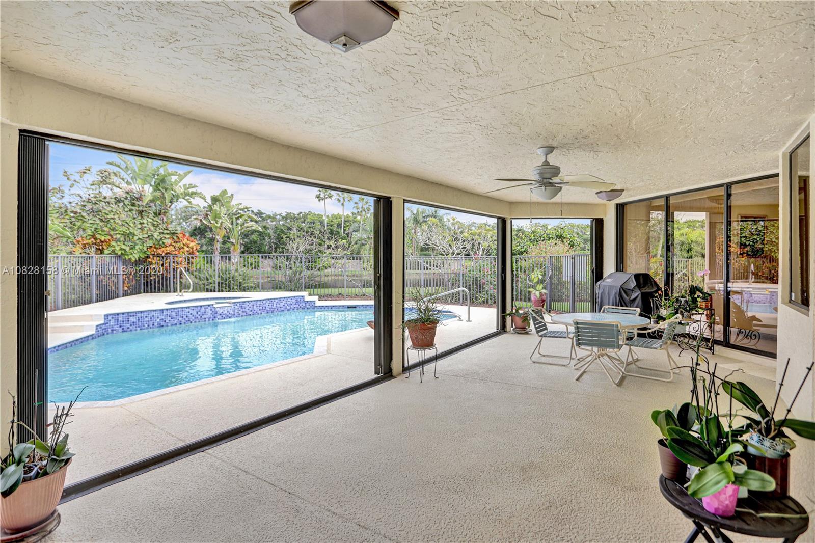 390 Alexandra Circle Weston, FL 33326 - Photo 44 of 71 a living room with furniture and floor to ceiling windows