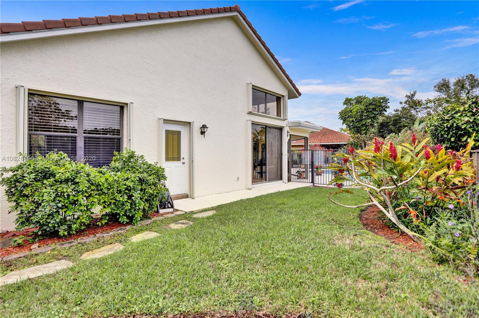 390 Alexandra Circle Weston, FL 33326 - Photo 49 of 71 a house view with a garden space