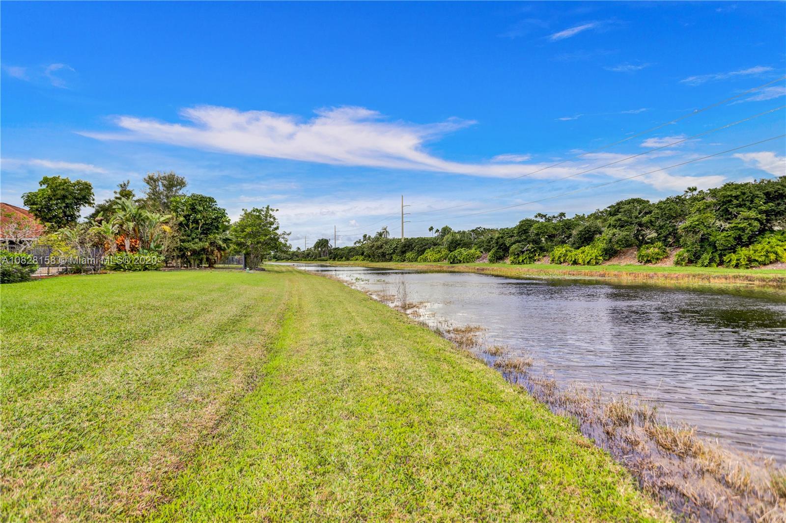 390 Alexandra Circle Weston, FL 33326 - Photo 53 of 71 a view of a lake with houses in the back