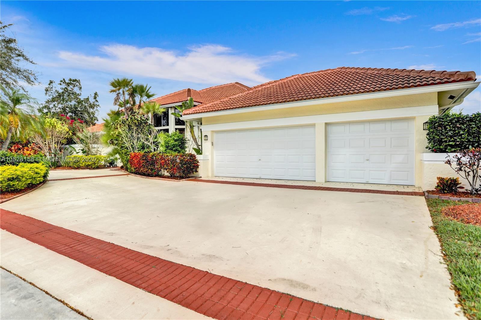 390 Alexandra Circle Weston, FL 33326 - Photo 6 of 71 a front view of a house with a yard and garage
