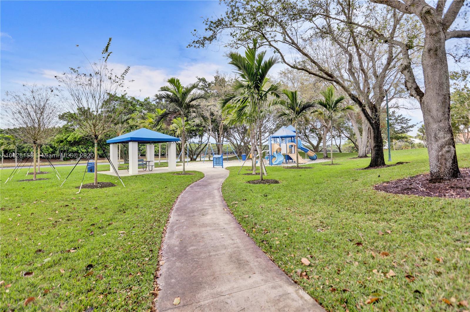 390 Alexandra Circle Weston, FL 33326 - Photo 62 of 71 a front view of a house with a yard
