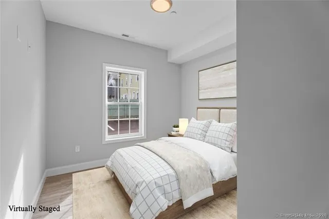 a bedroom with a bed and a window