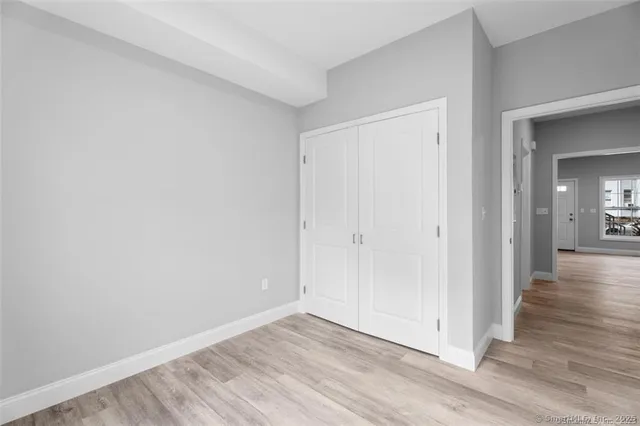 a view of an empty room and wooden floor