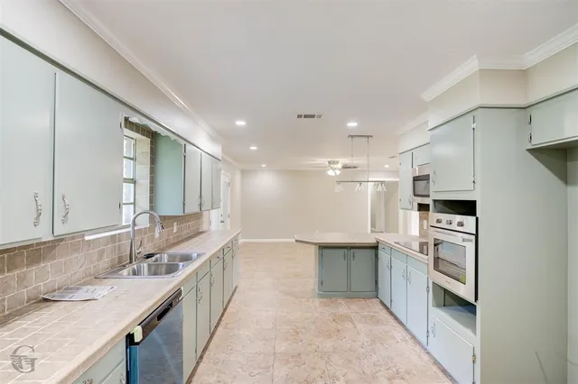 a kitchen with stainless steel appliances granite countertop a sink and cabinets