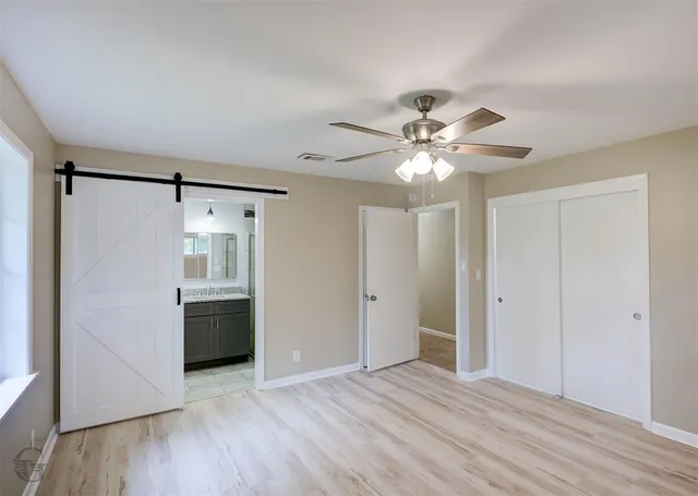 a view of an empty room with a kitchen