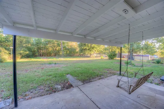 a view of a yard with a porch and garden