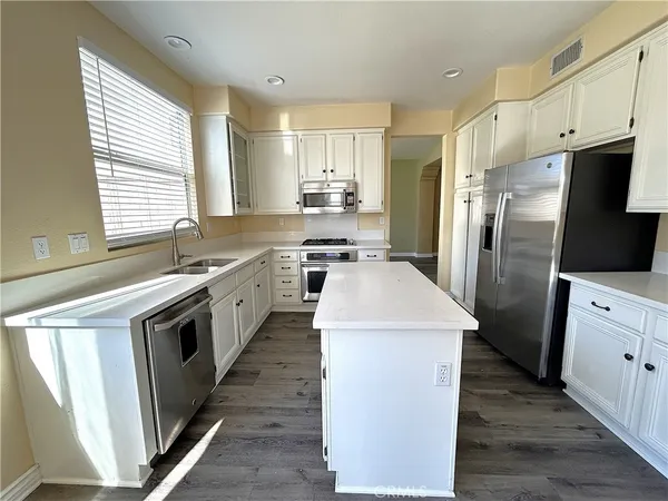 a kitchen with a sink stove and refrigerator