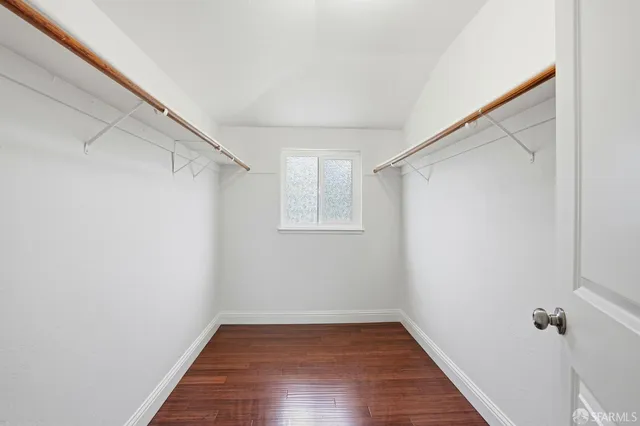 a view of a room with wooden floor and white walls