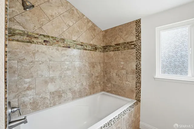 a bathroom with a tub and shower