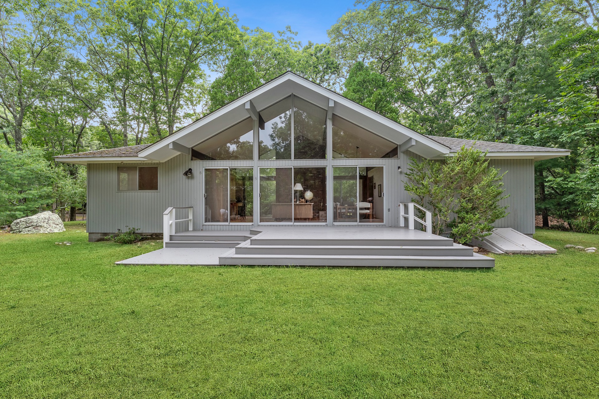 a view of a house with a yard and sitting area