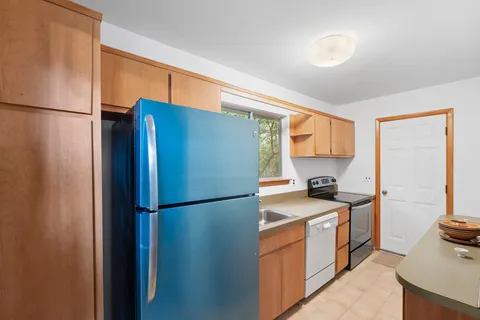 a kitchen with stainless steel appliances a refrigerator sink and stove