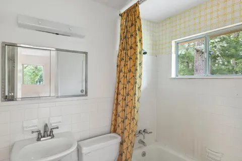 a bathroom with a sink a toilet and a bathtub