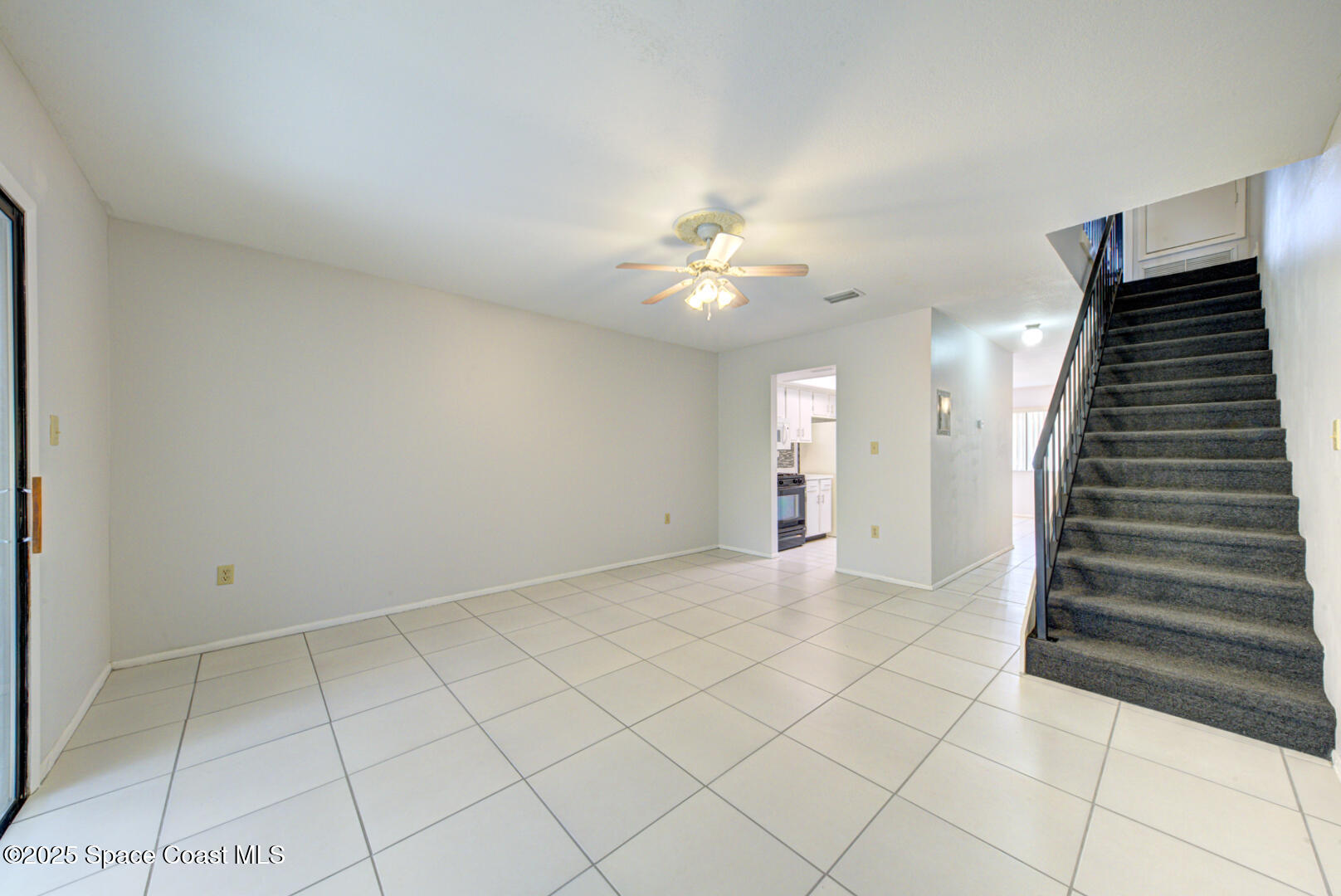 4749 Sisson Road Titusville, FL 32780 - Photo 13 of 30 family room & staircase