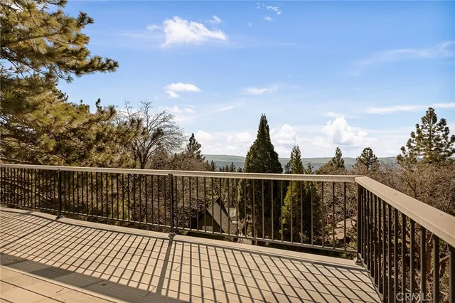 a view of balcony with wooden floor and fence