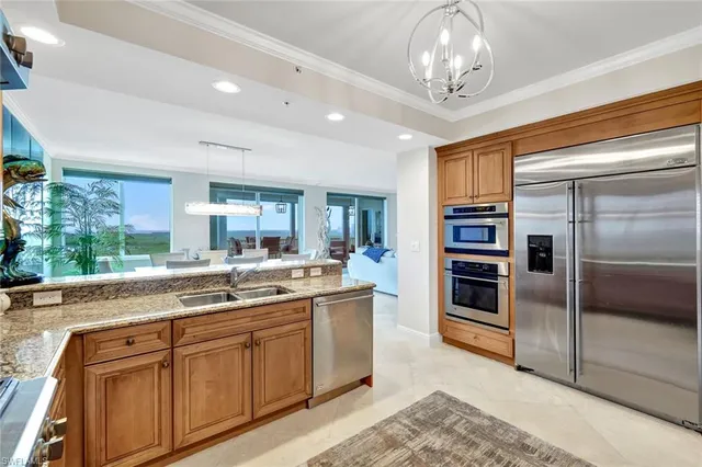 a kitchen with stainless steel appliances granite countertop a refrigerator and a sink