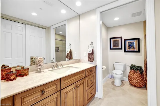 a spacious bathroom with a double vanity sink and a mirror