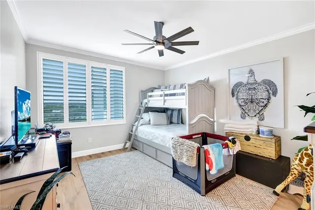 a bedroom with furniture and a large window