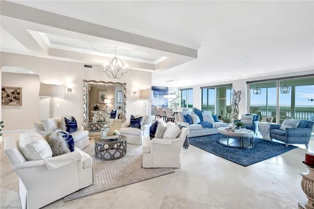 a living room with patio furniture and a large window