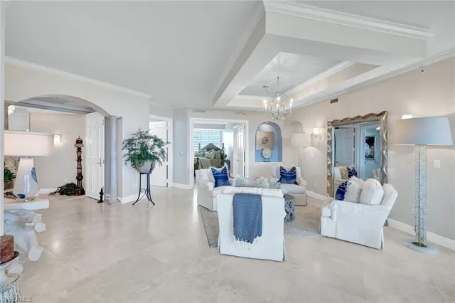 a living room with furniture and a chandelier