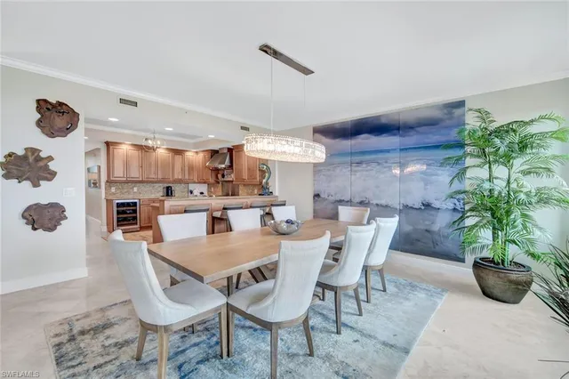 a view of a dining room with furniture and a potted plant