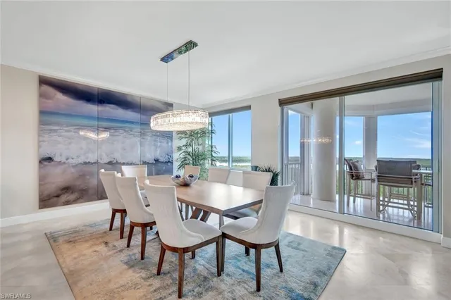 a dining room with furniture a chandelier and wooden floor