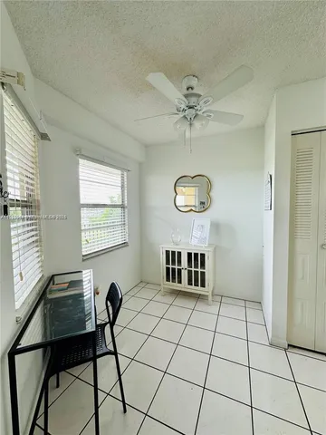 a view of a livingroom with furniture and chandelier fan