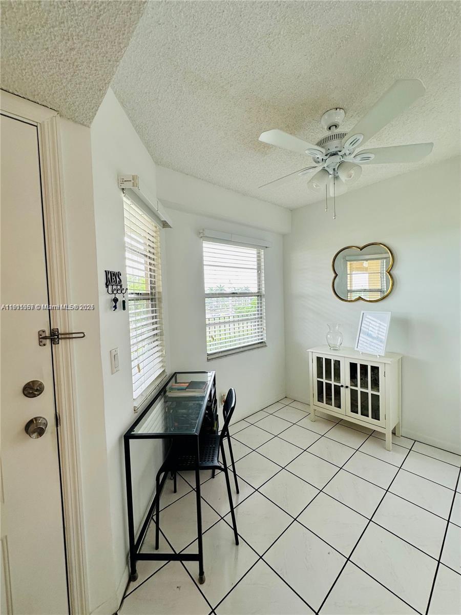 1400 Southwest 124th Terrace, Unit 402Q Pembroke Pines, FL 33027 - Photo 13 of 20 a view of a livingroom with furniture and chandelier fan